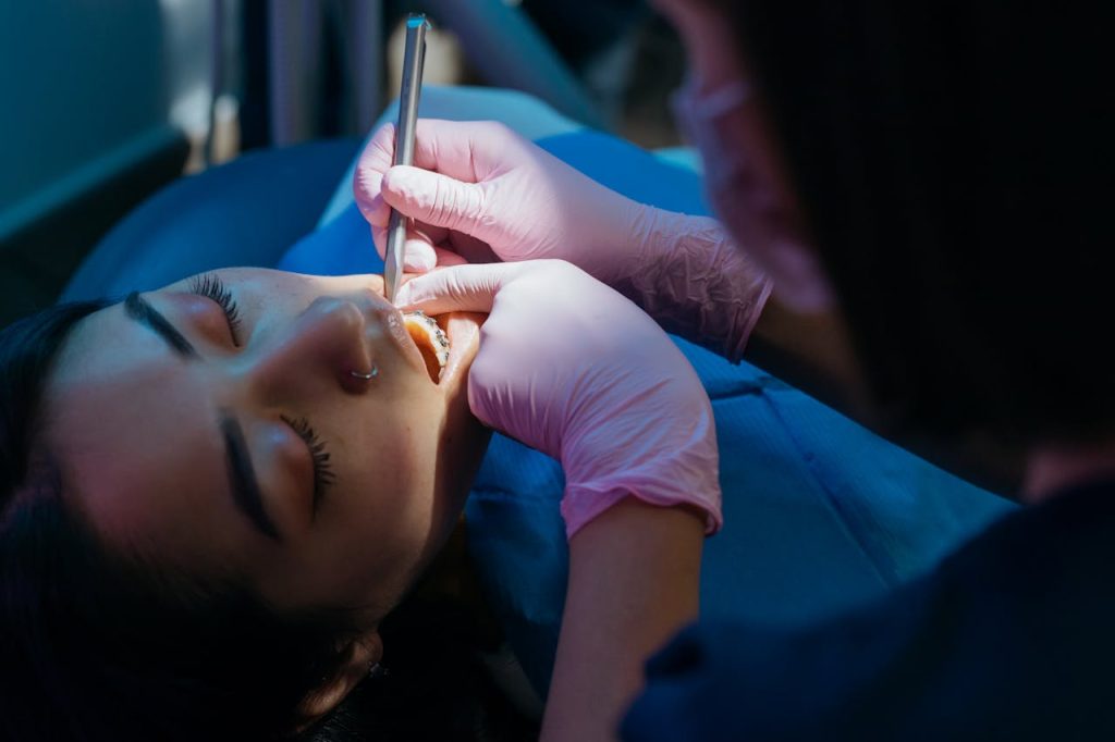 Close-up Photo of Dentist Examining Patient's Teeth